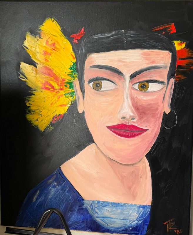 Portrait of a woman with short black hair and a large yellow flower, on a black background
