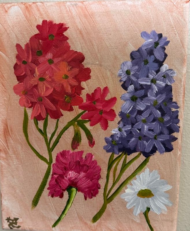 Red and pink flowers, purple hyacinth and a white daisy on a peach background