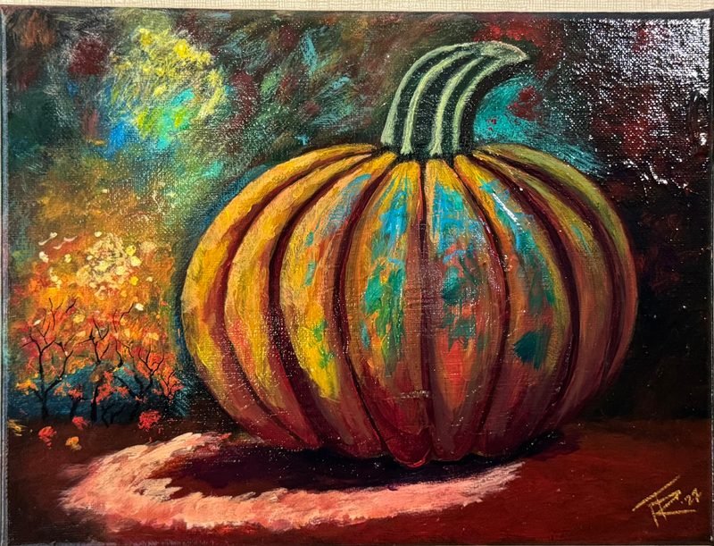 Large orange and teal pumpkin glowing in an autumn night scene